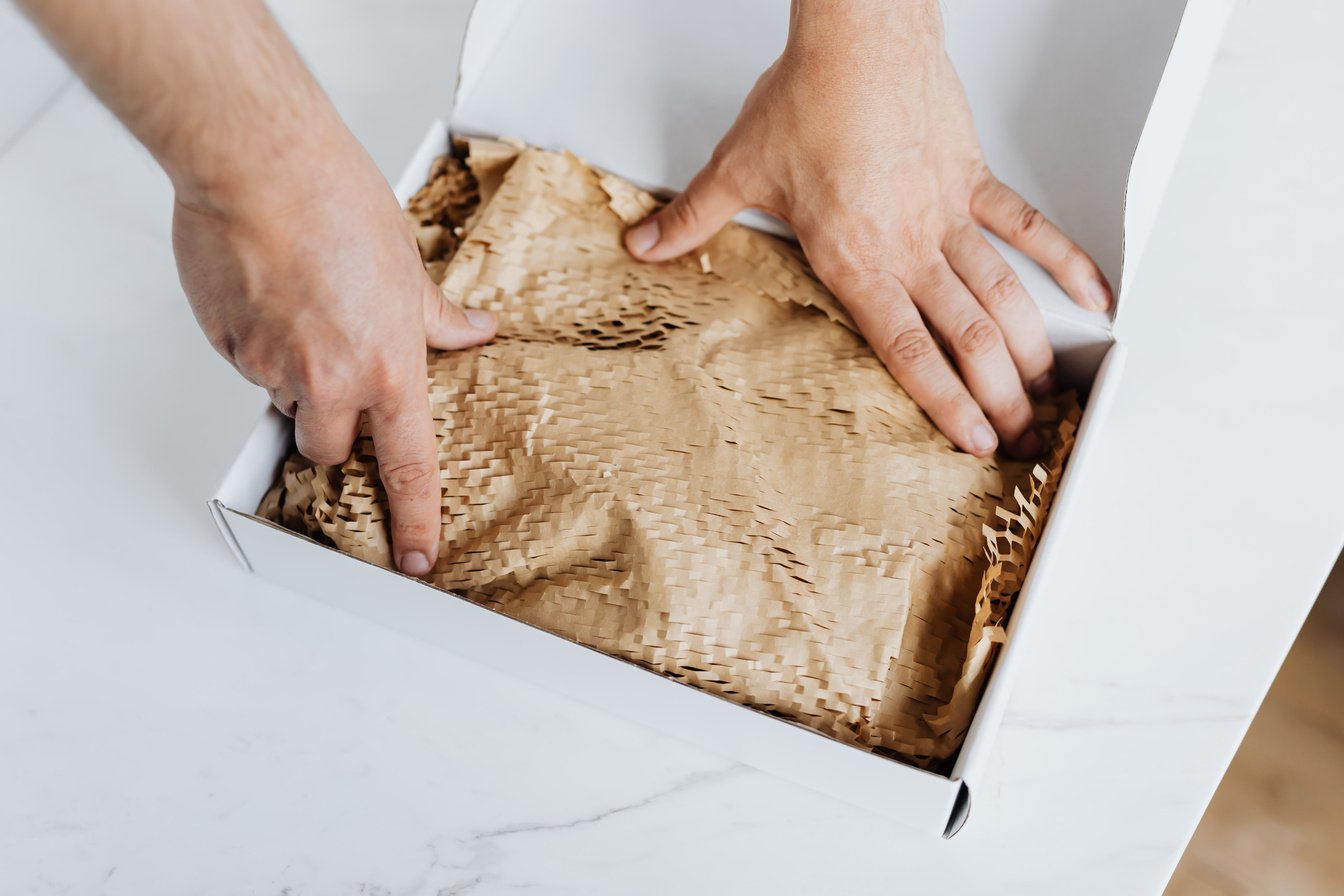 Anonymous man preparing package for shipment